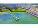 Aerial view of waterfront property with boat dock and building at 100 Bluff View Dr # 208B, Belleair Bluffs, FL 33770