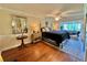 Spacious main bedroom with hardwood floors and access to a sitting area at 100 Bluff View Dr # 208B, Belleair Bluffs, FL 33770