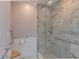 Bathroom with a large shower, marble tile and grab bars at 100 Bluff View Dr # 208B, Belleair Bluffs, FL 33770