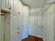 Large walk-in closet with built-in shelving and cabinets at 100 Bluff View Dr # 208B, Belleair Bluffs, FL 33770