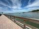 Brick paved walkway along waterfront with wooden railing at 100 Bluff View Dr # 208B, Belleair Bluffs, FL 33770