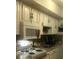 Well-equipped kitchen featuring white cabinets and granite countertops at 895 N Village N Dr # 204, St Petersburg, FL 33716