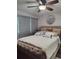 Comfortable bedroom with a king-size bed and ceiling fan at 895 N Village N Dr # 204, St Petersburg, FL 33716