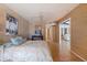 Bedroom with patterned wallpaper, ceiling fan, and access to another room at 1932 Arrowhead Ne Dr, St Petersburg, FL 33703