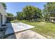 Large backyard with patio and mature trees at 4594 Essex Ln, Spring Hill, FL 34606