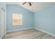 Bright bedroom with light blue walls and wood-look floors at 485 Harbor Ridge Dr, Palm Harbor, FL 34683