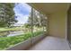 Relaxing screened porch overlooking a serene lake at 485 Harbor Ridge Dr, Palm Harbor, FL 34683