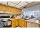 Kitchen with wood cabinets, appliances, and view at 6268 Palma Del Mar S Blvd # 407, St Petersburg, FL 33715
