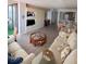 Bright living room featuring built-in shelving, wood floors, comfortable seating, and an adjacent dining area at 6268 Palma Del Mar S Blvd # 407, St Petersburg, FL 33715