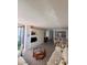 Bright living room featuring built-in shelving, wood floors, comfortable seating, and an adjacent dining area at 6268 Palma Del Mar S Blvd # 407, St Petersburg, FL 33715
