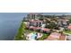 Aerial perspective of condo community with waterfront pool and lush landscaping at 6268 Palma Del Mar S Blvd # 407, St Petersburg, FL 33715