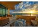 Enjoy breathtaking sunset views from this balcony, complete with comfortable wicker furniture at 1560 Gulf Blvd # 1107, Clearwater Beach, FL 33767