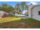 Large backyard with a wooden fence and patio area at 2502 Indigo Dr, Dunedin, FL 34698