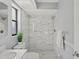 Updated bathroom with marble shower and white vanity at 2502 Indigo Dr, Dunedin, FL 34698