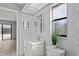 Updated bathroom with white vanity, toilet and a view of the backyard at 2502 Indigo Dr, Dunedin, FL 34698
