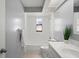 Clean bathroom with white vanity and bathtub at 2502 Indigo Dr, Dunedin, FL 34698