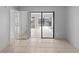 Bedroom with tile floors and sliding glass doors leading to sunroom at 2502 Indigo Dr, Dunedin, FL 34698
