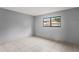 Spacious bedroom with large window and tile floors at 2502 Indigo Dr, Dunedin, FL 34698