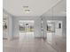 Bright dining room with tile floors and view into Gathering room at 2502 Indigo Dr, Dunedin, FL 34698