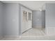 Spacious entryway with white double doors and mirrored wall at 2502 Indigo Dr, Dunedin, FL 34698