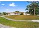 Single-story home with attached garage and landscaped yard at 2502 Indigo Dr, Dunedin, FL 34698