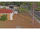 Back of house showing stone exterior and fence at 2502 Indigo Dr, Dunedin, FL 34698