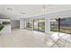 Bright Gathering room with tile floors and sliding glass doors leading to the backyard at 2502 Indigo Dr, Dunedin, FL 34698