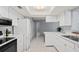 Well-lit kitchen boasts ample counter space, white appliances, and tile flooring at 2502 Indigo Dr, Dunedin, FL 34698