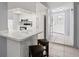 Kitchen with breakfast bar, view of the entrance, and two stools at 2502 Indigo Dr, Dunedin, FL 34698