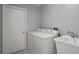Laundry room with washer, dryer, and utility sink at 2502 Indigo Dr, Dunedin, FL 34698