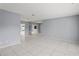 Living room with tile floors, mirrored wall and view to kitchen at 2502 Indigo Dr, Dunedin, FL 34698