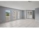 Open living room with tile flooring and large windows at 2502 Indigo Dr, Dunedin, FL 34698