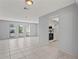 Spacious living room with tile floors and kitchen access at 2502 Indigo Dr, Dunedin, FL 34698