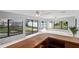 Bright living area with large windows, tile floors, and a wet bar at 2502 Indigo Dr, Dunedin, FL 34698