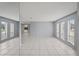 Bright living room with tile floors and mirrored wall at 2502 Indigo Dr, Dunedin, FL 34698