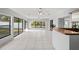 Sunroom features tile flooring, sliding glass doors and a built-in bar at 2502 Indigo Dr, Dunedin, FL 34698