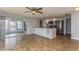 Open kitchen with island, white cabinets, and wood-look tile floor at 4145 Star Island Dr, Holiday, FL 34691