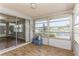 Bright sunroom with tile floors and water views at 4145 Star Island Dr, Holiday, FL 34691