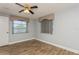 Bedroom with tile floors, two windows, and ceiling fan at 4145 Star Island Dr, Holiday, FL 34691