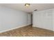 Bedroom with wood-look floors, light walls and door to hallway at 4145 Star Island Dr, Holiday, FL 34691