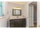 Updated bathroom with dark vanity, new lighting and tile flooring at 4145 Star Island Dr, Holiday, FL 34691