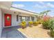 Inviting house exterior featuring a red door and well-manicured landscaping at 4145 Star Island Dr, Holiday, FL 34691