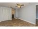 Bedroom with tile floors, ceiling fan and access to bathroom at 4145 Star Island Dr, Holiday, FL 34691