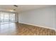 Bright living room with tile floors and view to enclosed patio at 4145 Star Island Dr, Holiday, FL 34691