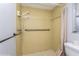 Walk-in shower with beige tile and grab bars for accessibility at 4145 Star Island Dr, Holiday, FL 34691