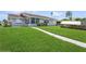 Spacious backyard with walkway to house at 4145 Star Island Dr, Holiday, FL 34691
