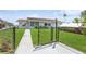 Backyard with walkway, fence, and chicken coop at 4145 Star Island Dr, Holiday, FL 34691