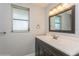 Clean bathroom with dark vanity, mirror and tile flooring at 4145 Star Island Dr, Holiday, FL 34691