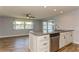 Bright living room with wood-look tile floor and sliding glass doors at 4145 Star Island Dr, Holiday, FL 34691