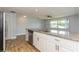Modern kitchen with white cabinets, granite countertops, and stainless steel appliances at 4145 Star Island Dr, Holiday, FL 34691
